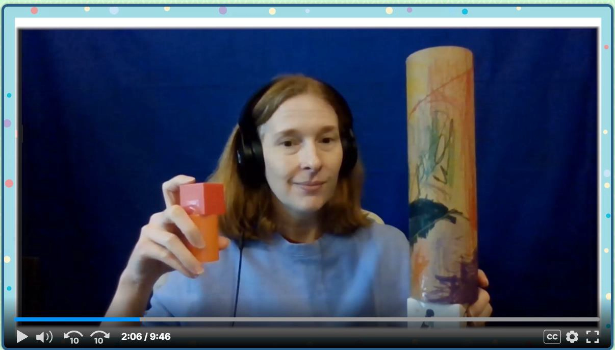 A person with headphones holds a small red-orange shaker in one hand and a tall, decorated rainstick in the other, sitting in front of a blue background during a video call to demonstrate real world math activities.